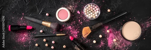 Obraz Professional makeup panorama on a dark background. Brushes, lipstick and other products, a flat lay