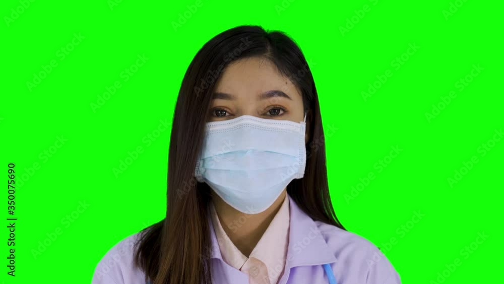 female doctor with medical mask on green screen background female doctor with medical mask on green screen background