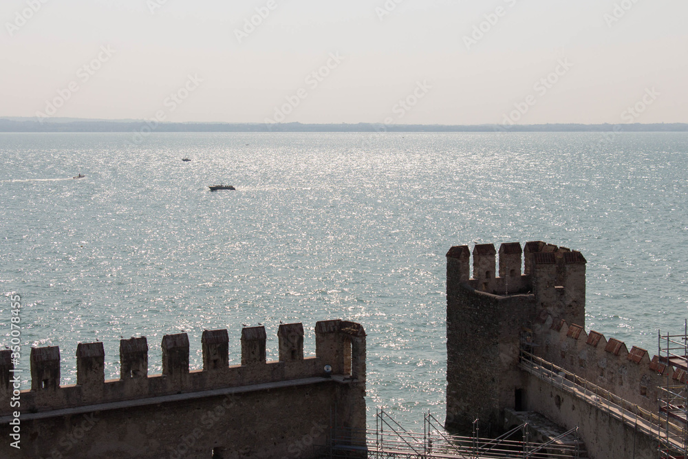 Scaliger Castle fortificated walls with horizon line on background, Sirmione, Lombardy, Italy.