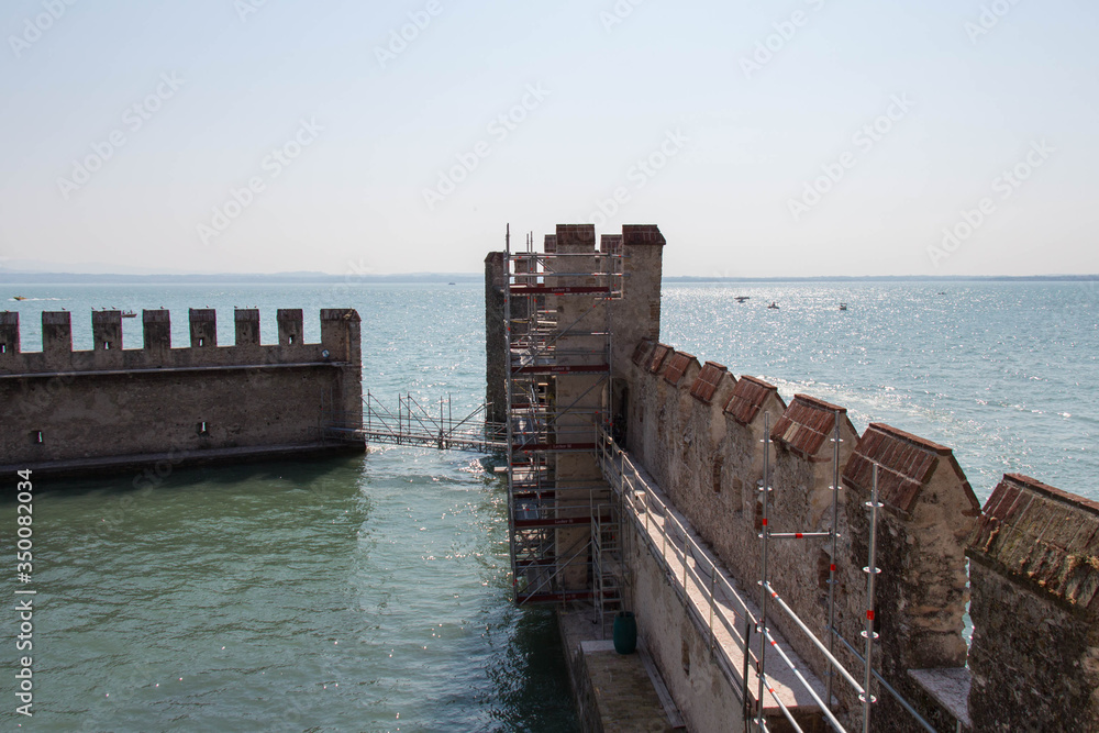 Reconstruction of Scaliger Castle fortification walls with horizon line on background, Sirmione, Lombardy, Italy.