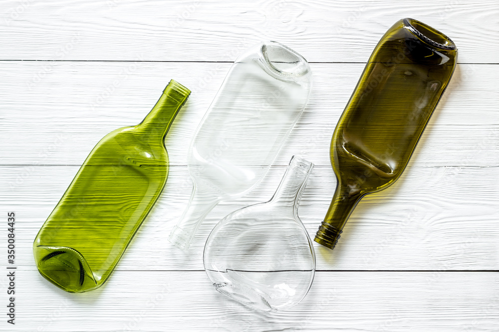 Fototapeta premium Pattern of bottles on white wooden background top view