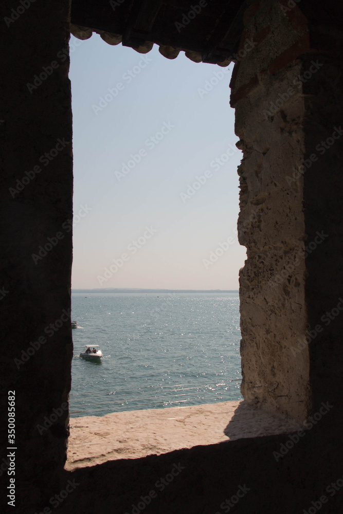 Sea and horizon line view from ancient medieval window.