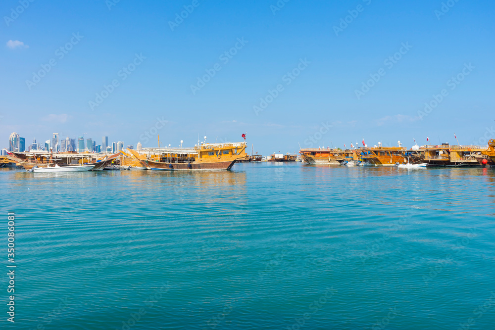 Traditional boats called Dhows are anchored in the port near Museum of Islamic Art Park,Doha, Qatar.