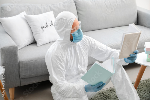 Man in biohazard suit readi...