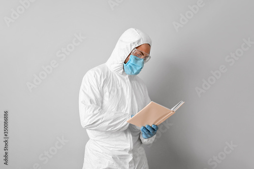 Man in biohazard suit readi...