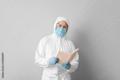 Man in biohazard suit readi...