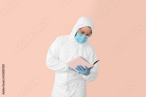 Man in biohazard suit readi...