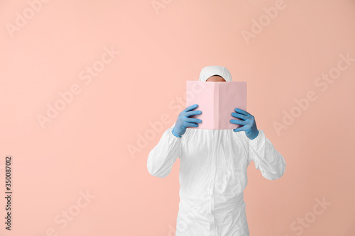 Man in biohazard suit readi...