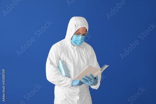 Man in biohazard suit readi...