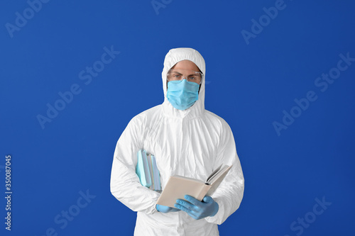 Man in biohazard suit readi...