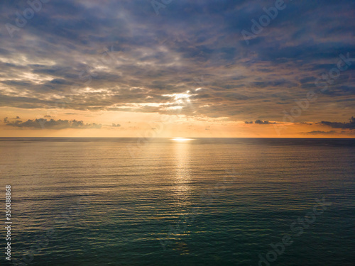 Aerial Drone view sunset over the sea with cloud and sun light with copy space. © AKGK Studio