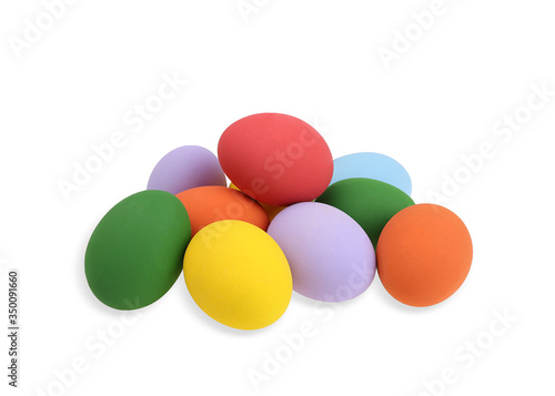 A pile of painted eggs in various colors isolated on white background. © Chaiwat