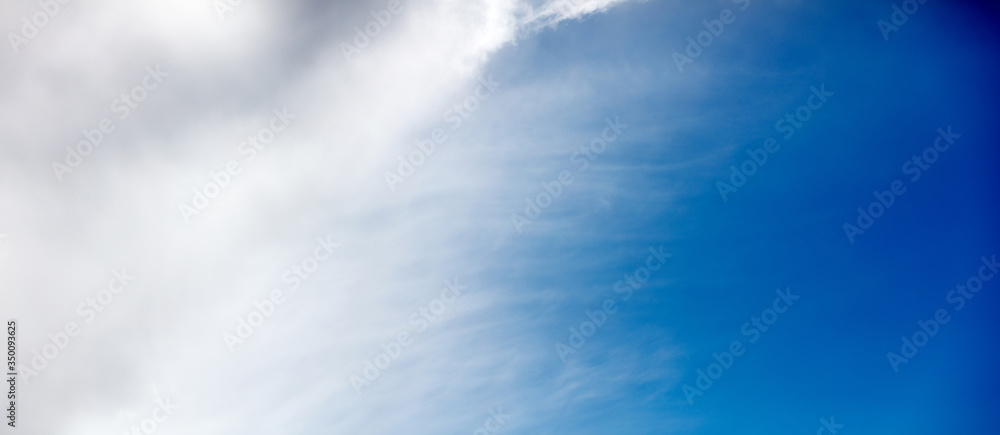 A wide background with clouds that blend seamlessly into the sky