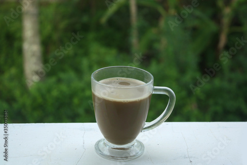 milk coffee cappuccino on table with nature background