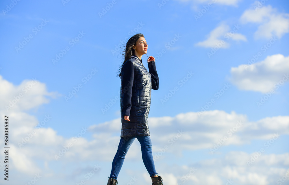 Dreamy girl. Young and free concept. Expect more from your clothes. Woman enjoy weather outdoors. Beauty and fashion. Walking alone. Woman on blue sky background. Winter vacation. Long jacket coat Dreamy girl. Young and free concept. Expect more from your clothes. Woman enjoy weather outdoors. Beauty and fashion. Walking alone. Woman on blue sky background. Winter vacation. Long jacket coat