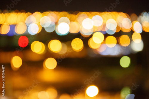 Dark classic bokeh background. Defocus image with colorful lights in bokeh. Night life of the city © Olga Mishyna