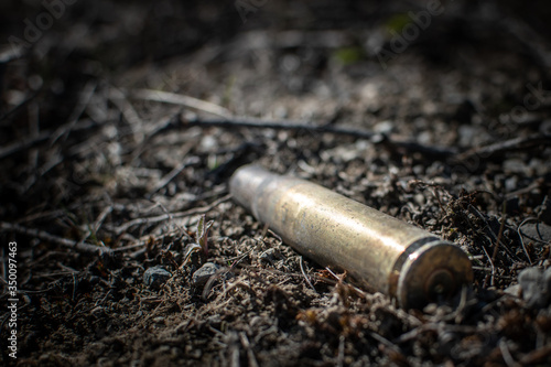 Used rifle shell left on the ground.