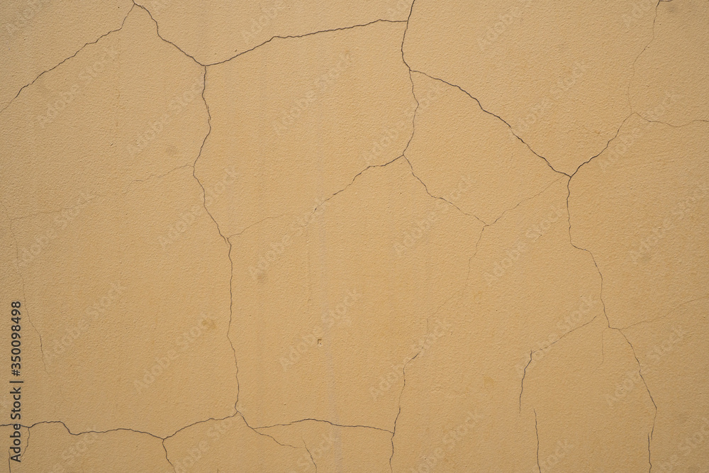 Background image of the texture of a painted cracked wall Background image of the texture of a painted cracked wall