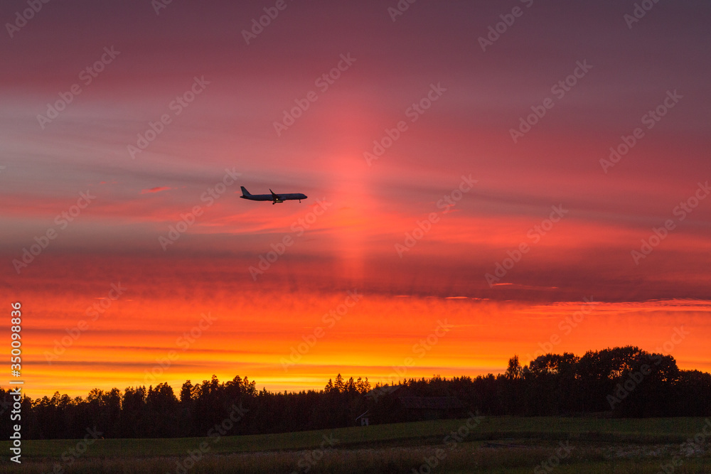 Airplane flying against the sunset Airplane flying against the sunset
