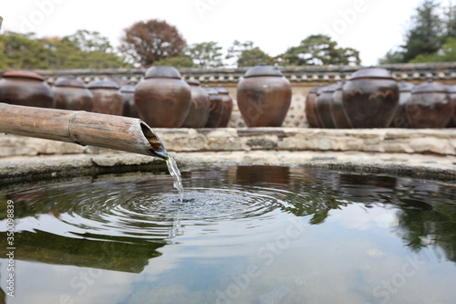 Beautiful traditional Korean jar and clean mineral water photo