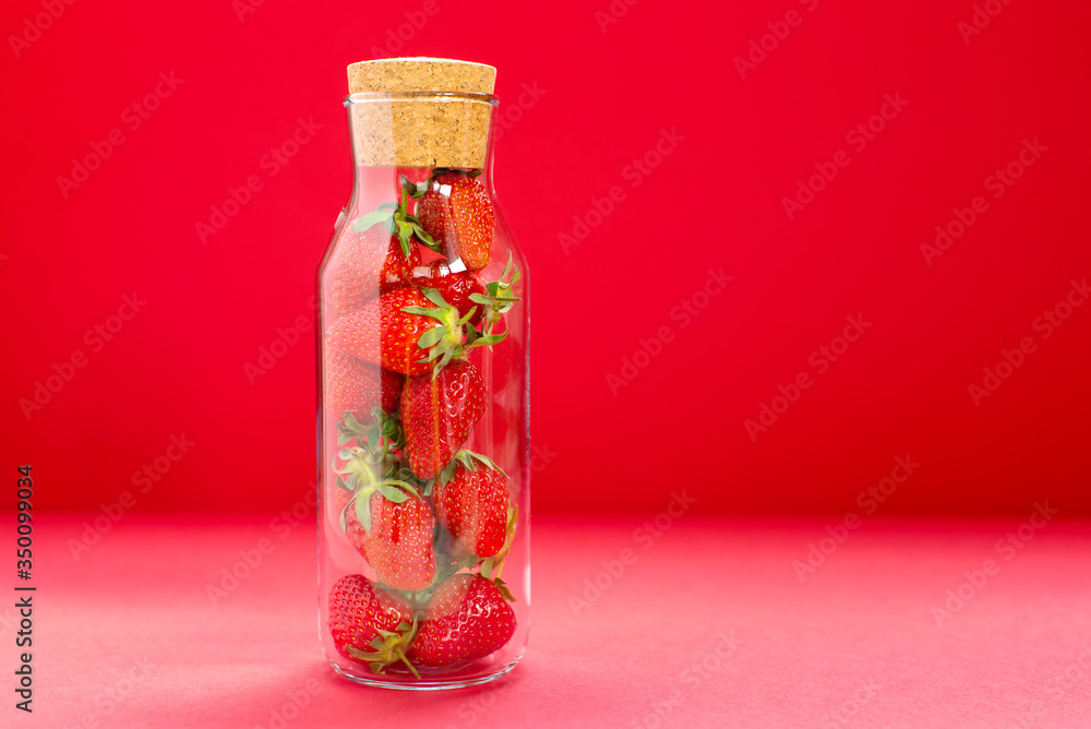 Bright juicy selected strawberries in a glass bottle. Bright juicy selected strawberries in a glass bottle.