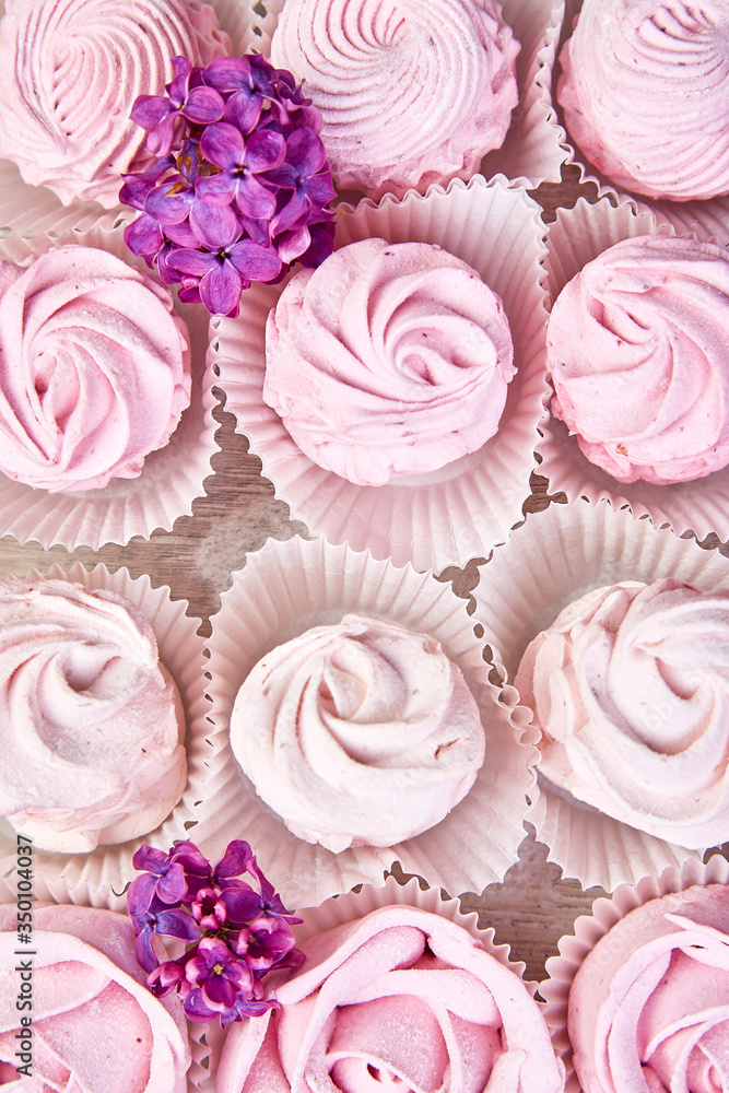 Violet sweet homemade marshmallow from blackcurrant near lilac flowers Violet sweet homemade marshmallow from blackcurrant near lilac flowers