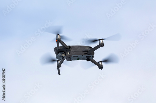 Fototapeta Naklejka Na Ścianę i Meble -  Drone with a camcorder against a clear sky