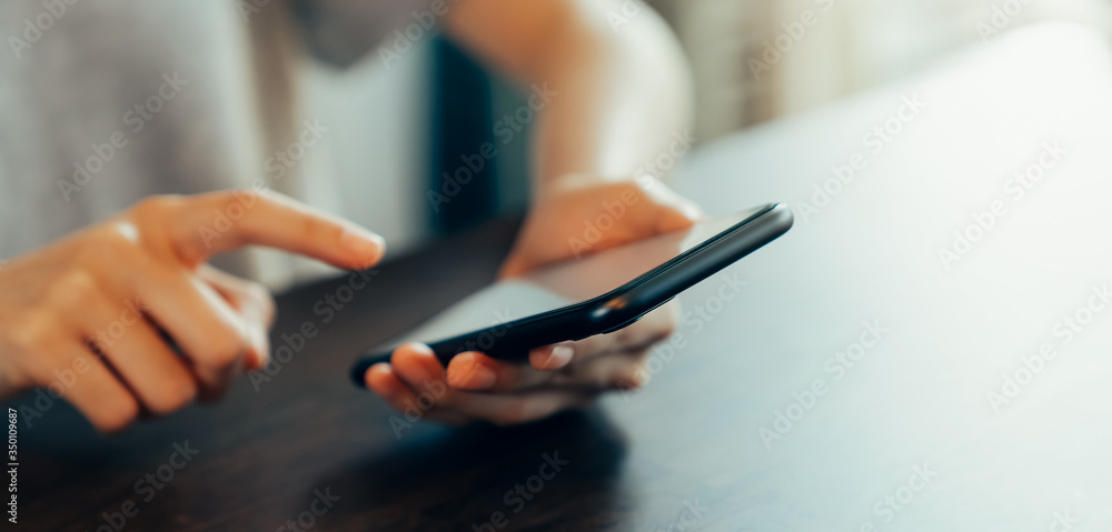 Closeup of young woman hand holding smartphone and chatting with friends at social network. Closeup of young woman hand holding smartphone and chatting with friends at social network.