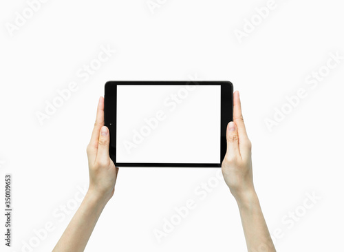 Close-up of hand holding black tablet isolated on white background.