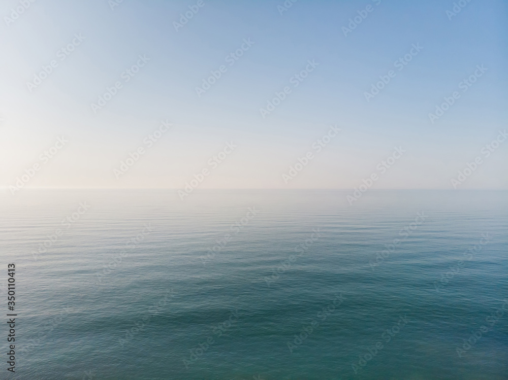 Seascape with sea horizon and blue sky. Background and wallpaper concept. Aerial view.