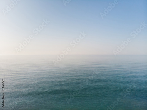 Seascape with sea horizon and blue sky. Background and wallpaper concept. Aerial view.