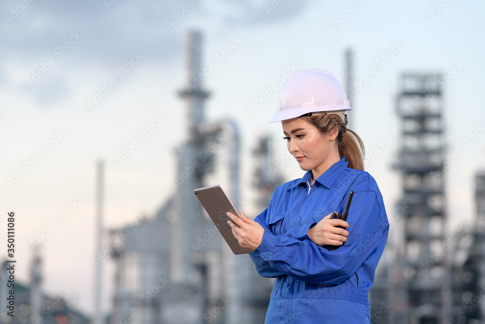 The women engineer work safety control and seeing Tablet drawing at power plant energy industry , Thailand. Engineer Concept. The women engineer work safety control and seeing Tablet drawing at power plant energy industry , Thailand. Engineer Concept.
