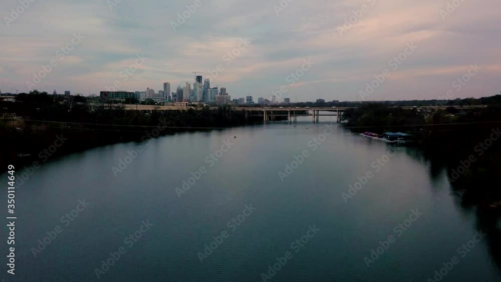 Canoeing alone on lake with the downtown Austin, Texas skyline in the distance Canoeing alone on lake with the downtown Austin, Texas skyline in the distance