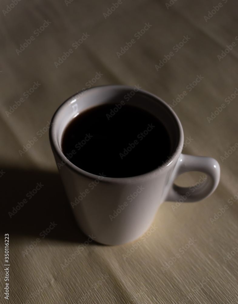 White cup of coffee on a white background