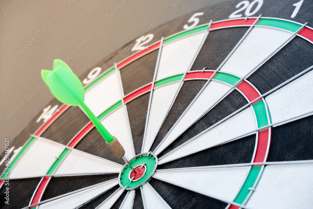 The arrow in the middle of the dartboard Demonstrate the concept of a successful business goal The arrow in the middle of the dartboard Demonstrate the concept of a successful business goal