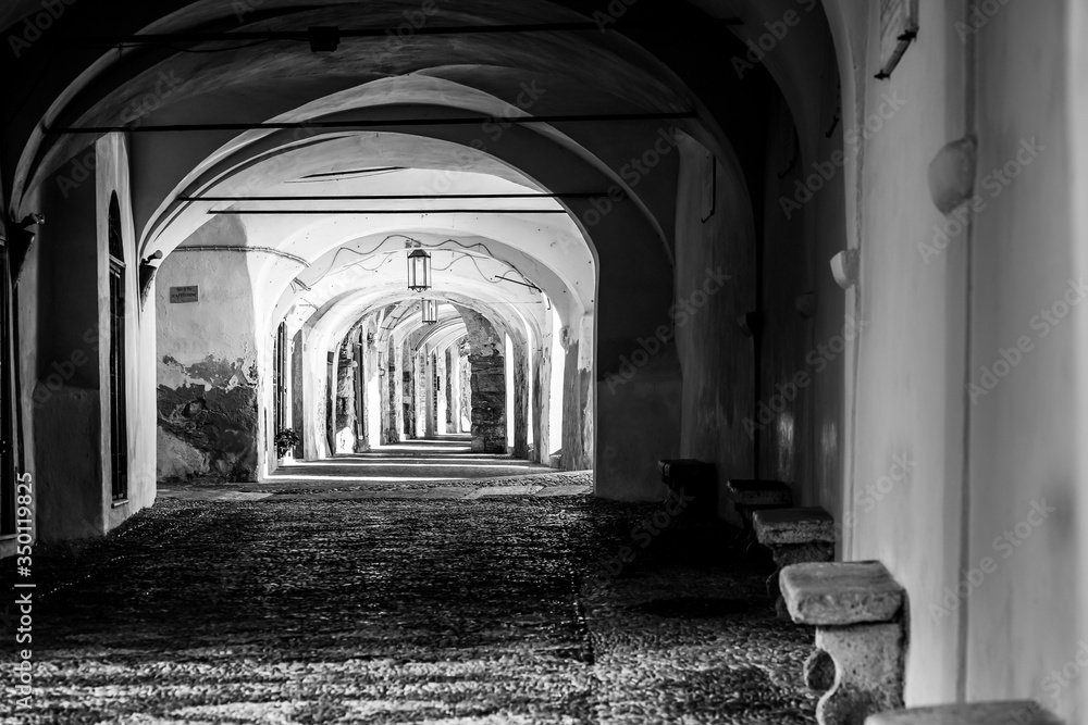 black and white photo of an arcade in the medieval town of Noli, Savona, Italy