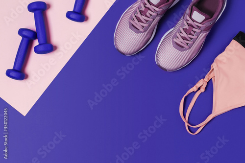 Sports equipment for training at home. Pink-blue background, diagonal composition.