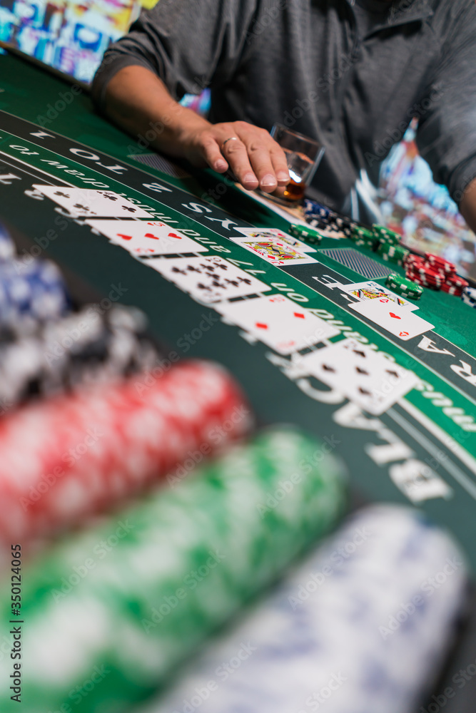 Fototapeta premium Man playing BlackJack at the casino