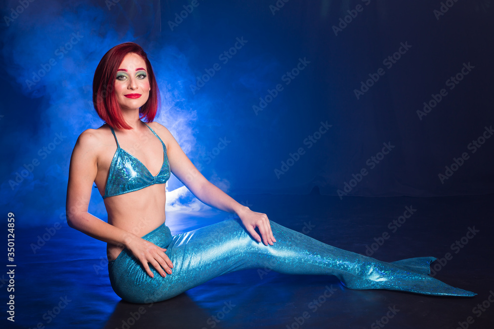 Obraz premium Fashion fantasy mermaid. Studio Shot. Blue underwater background. Fairy tales concept.