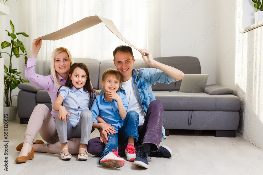 concept housing a young family. Mother father and child in new house with a roof concept housing a young family. Mother father and child in new house with a roof