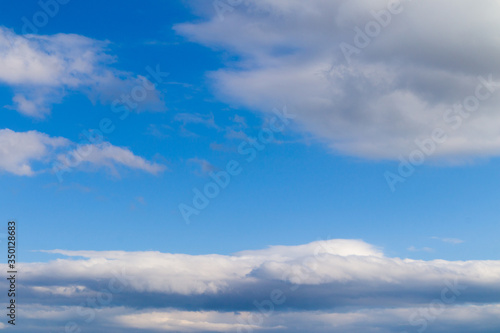 Fototapeta Naklejka Na Ścianę i Meble -  Many white clouds on the blue clean sky in a day. 