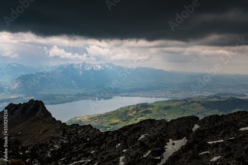view from the peak of Sigriswiler Rothorn during a thunderstorm with Thun and Lake Thun