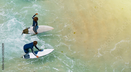 Photography Young surfer sport man carrying his surfing board and going to ocean top view