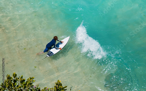 Photography Young surfer sport man carrying his surfing board and going to ocean top view