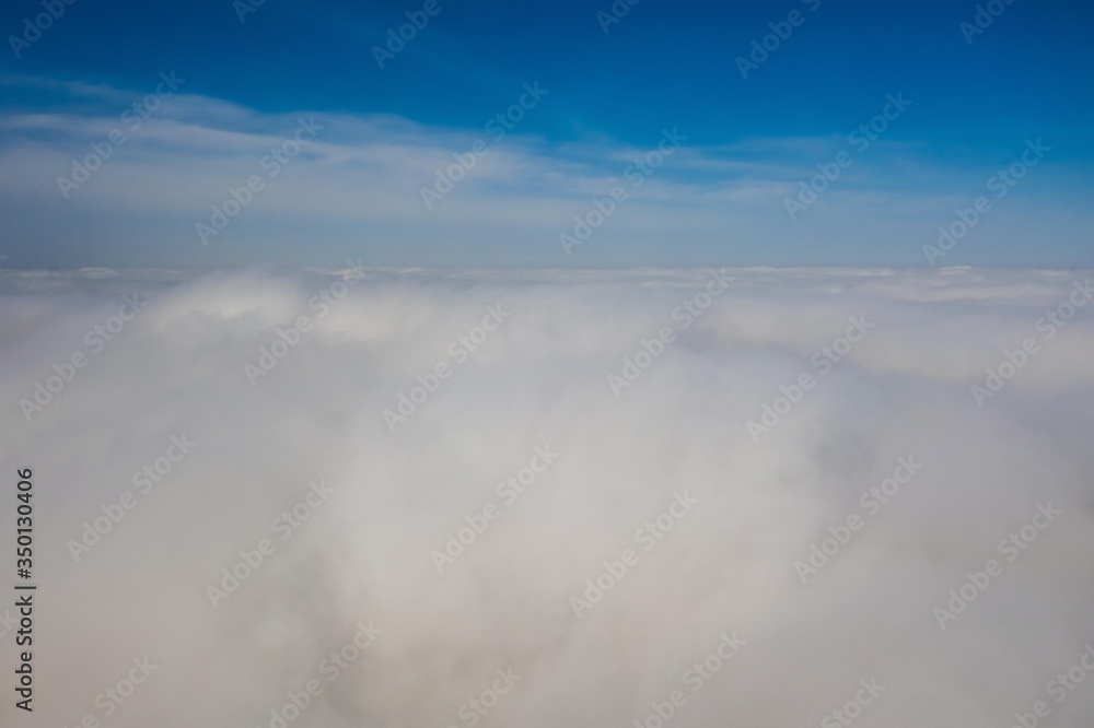 Flying in the sky over the clouds.