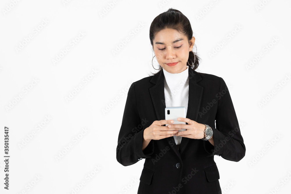 Smiling happy young Asian business woman in suit holding mobile smart phone over white isolated background. Smiling happy young Asian business woman in suit holding mobile smart phone over white isolated background.