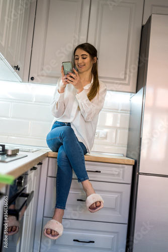 portrait of young beautiful girl posing in the kitchen