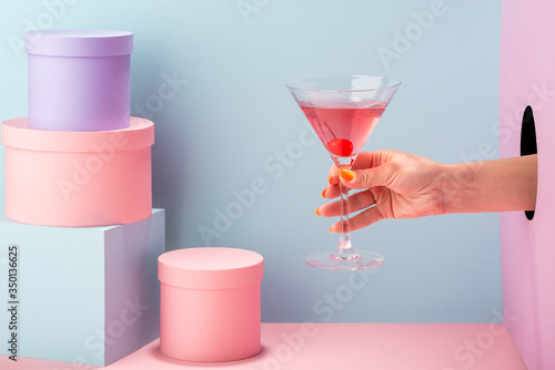 Sticker Close-up on woman's hand holding a glass of red prosecco
