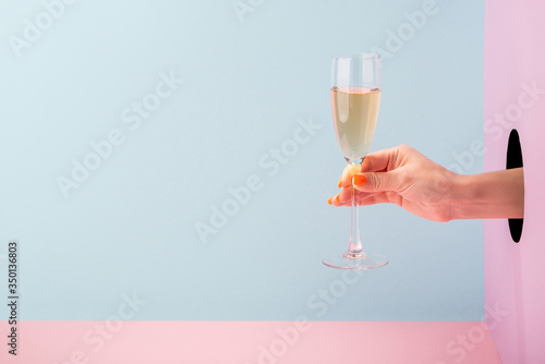 Woman's hand holding a glass of champagne photo