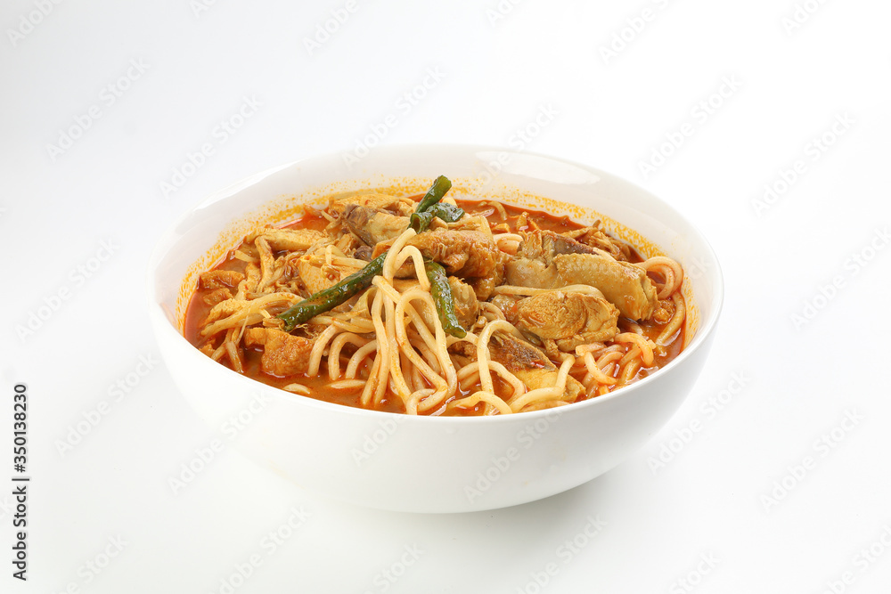 Malaysian curry yellow mee noodle with roasted chicken slice in white bowl on white background